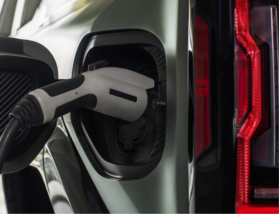 Close up of charging port with charger plugged in on a GMC Hummer EV SUV - Champion GMC in McMinnville TN
